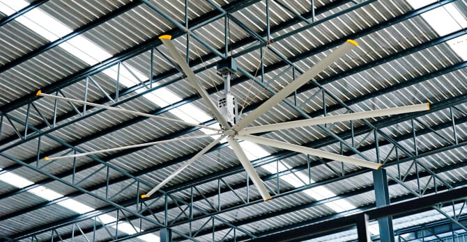 Large electric roof fan on factory ceiling 