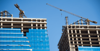 Construction cranes building towering buildings