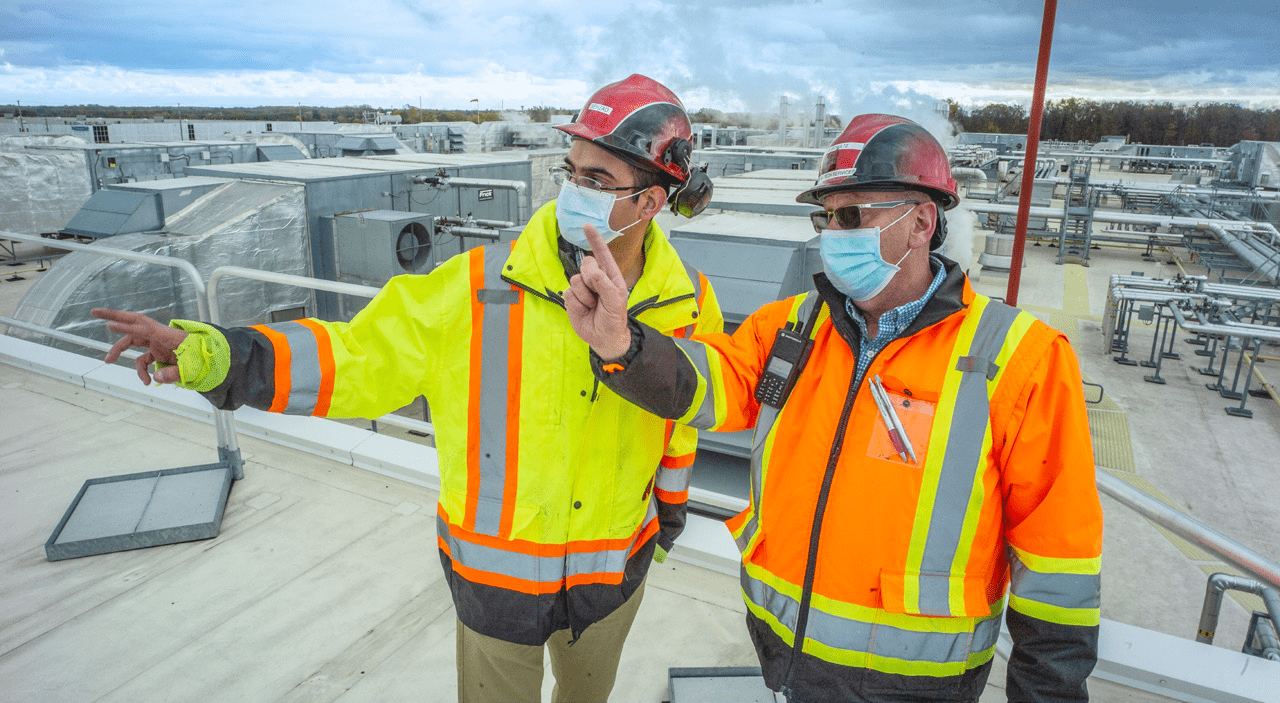 Enbridge Gas employee and Maple Leaf Foods employee showing the heat recovery units on the plant