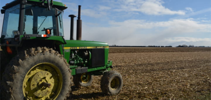 A tractor on a freshly harvested field.