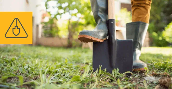 A person digging ground using showel