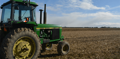 Tractor traveling across farm land