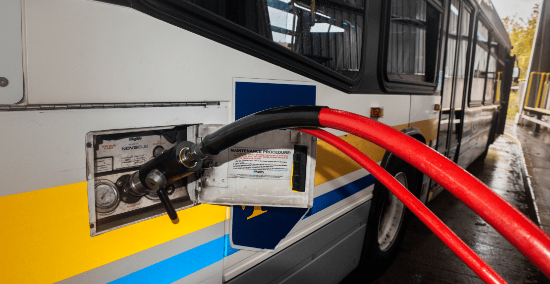 Closeup of a CNG bus being re-fuelled.