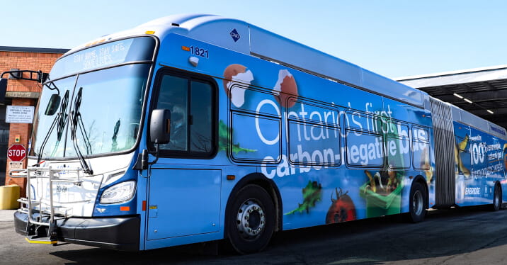 The exterior of a Hamilton Street Railway bus. The side of the bus reads ""Canada's first carbon-negative bus.""