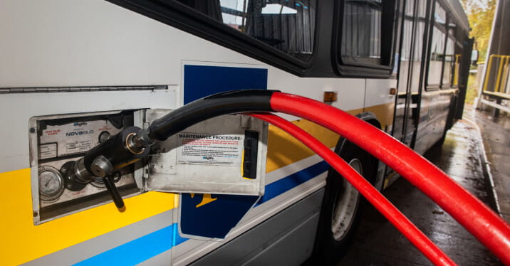Closeup of a CNG bus being re-fuelled.