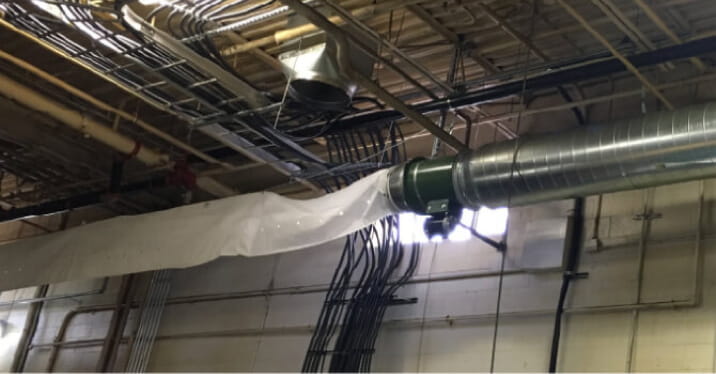 Pipes and vents on ceiling of factory building.