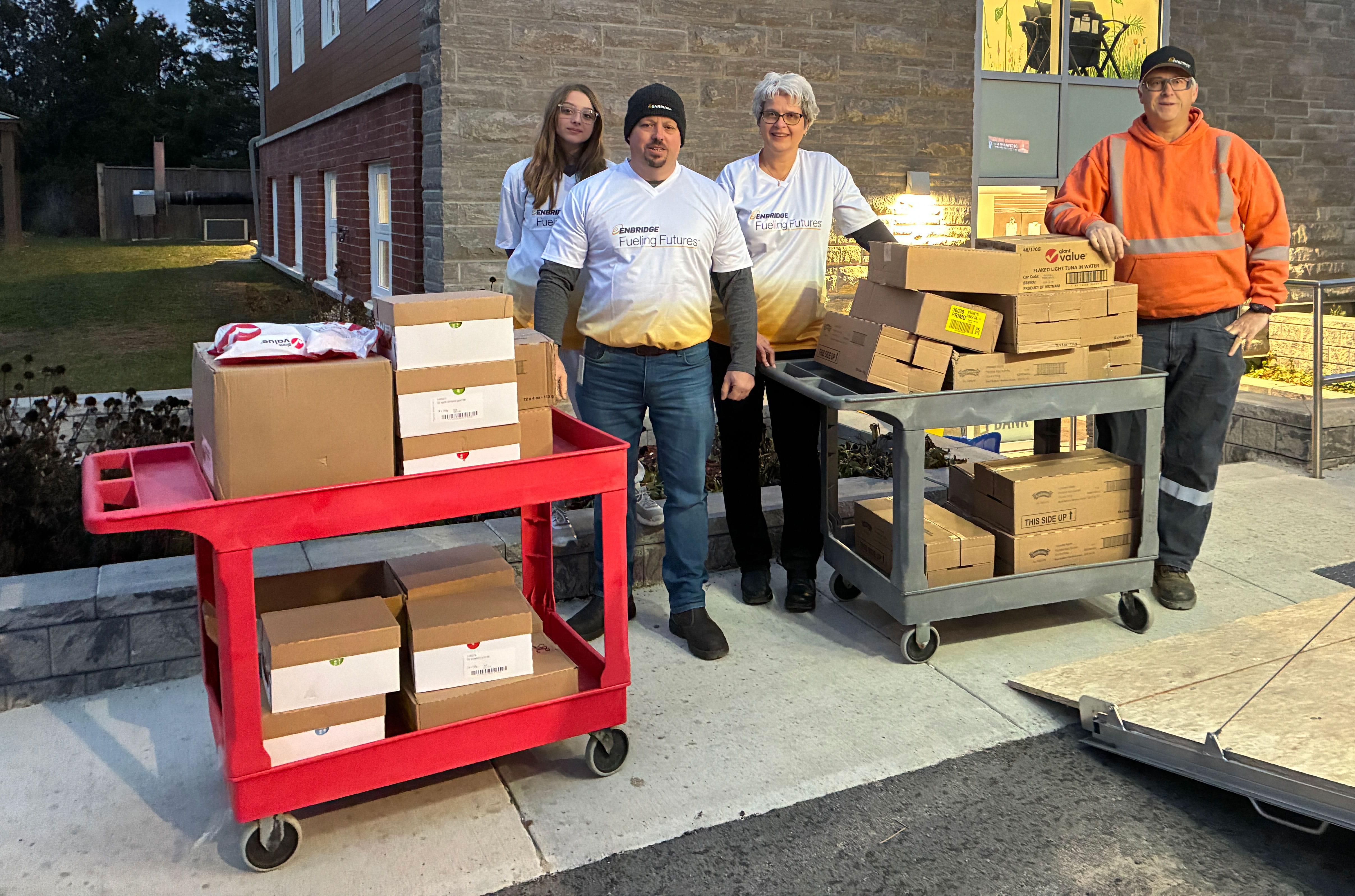 A group of Enbridge Gas employees posing with packaged items prepared for donation.