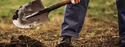 The gardener digs the garden with a shovel 