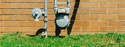 Natural gas meter with lawn below.
