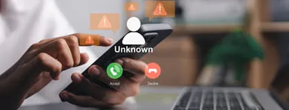Close up of hands holding smartphone with unknown incoming call alert and warning icons.