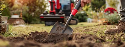 The gardener digs the garden with a shovel 