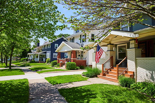 Charming American Townhouses with Flag, Sunny Suburban Street