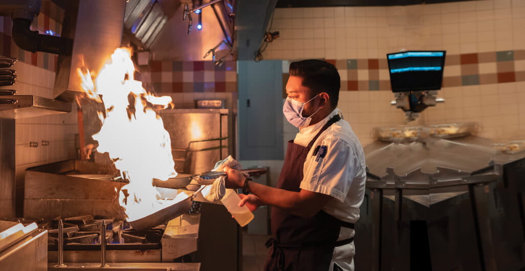 Chef cooking over a stove