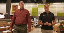 Two people walking in a grocery store