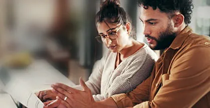Two people looking at a computer screen.