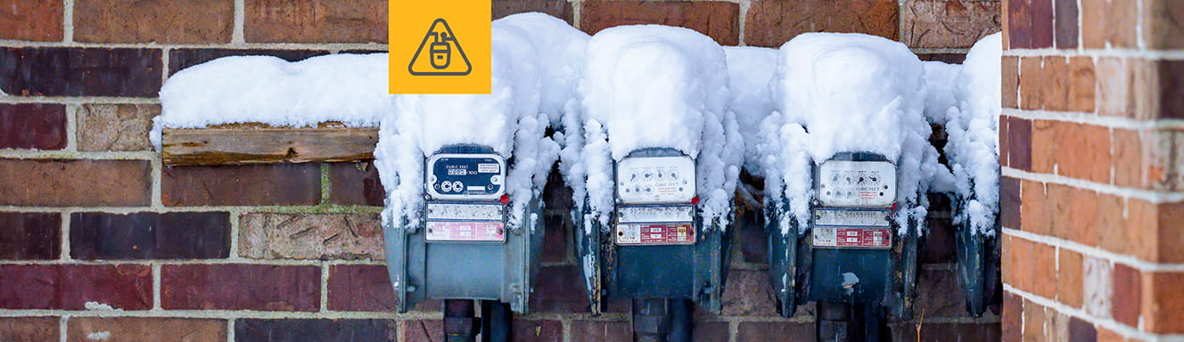 Natural gas meters covered in snow.
