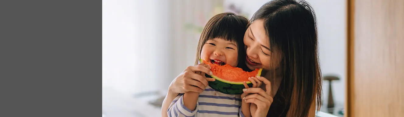 Mother and child eating watermelon