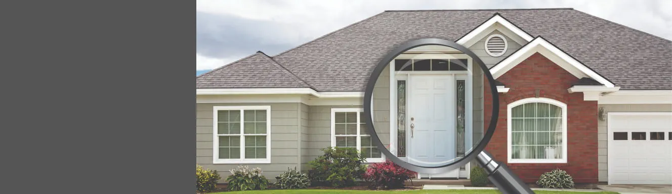 A magnifying glass over a residential house
