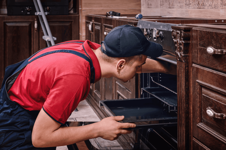 A professional installer overseeing an oven installation