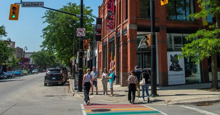 A group of people walking on a street.
