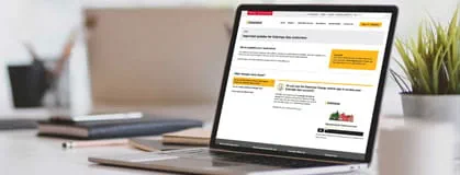 Open laptop in modern workplace with office supplies and decorations