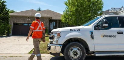 Enbridge truck and a staff working in a residential area.